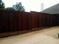 Stained stepped cedar fence